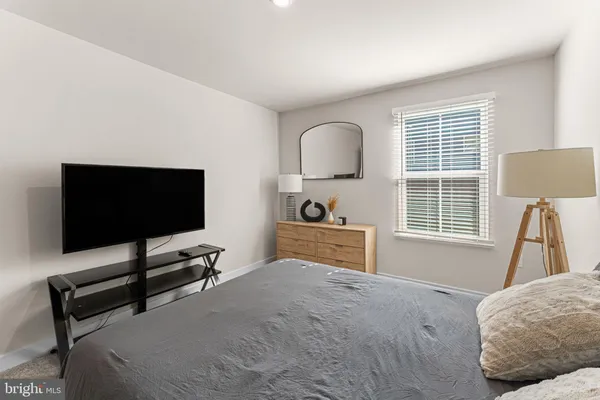 a bedroom with furniture and a flat screen tv