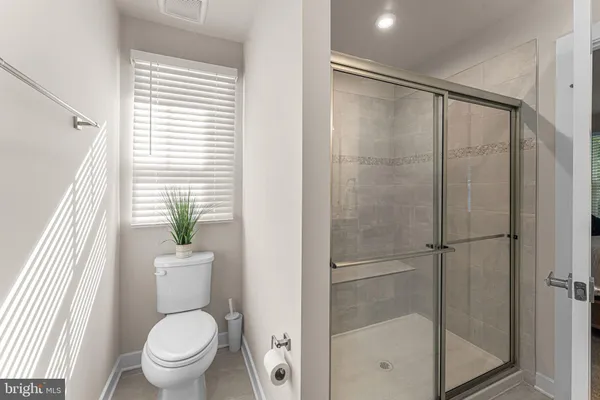 a bathroom with a shower and toilet