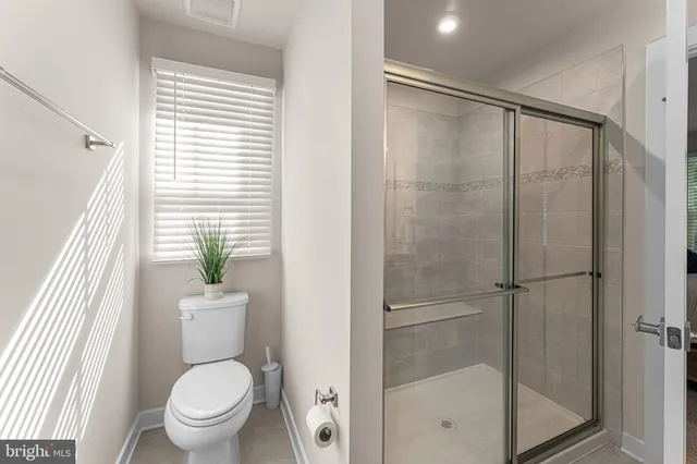 a bathroom with a shower and toilet