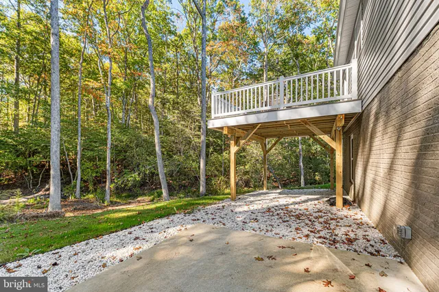 a bathroom with a toilet a sink a mirror and shower