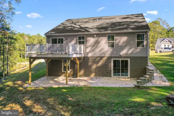 a view of a house with backyard porch and sitting area