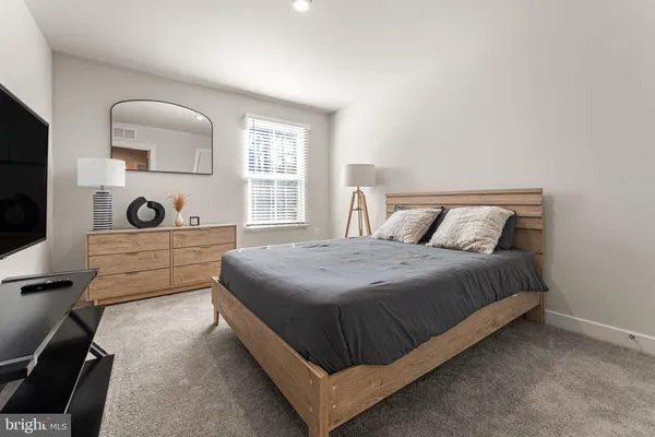 a bedroom with a bed and window