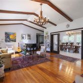 a living room with dining room and wooden floor