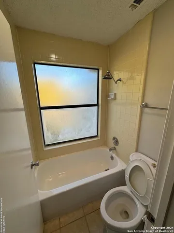 a bathroom with a toilet a sink and bathtub