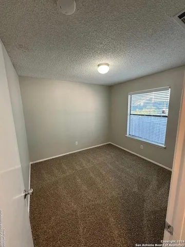 an empty room with a empty space and windows