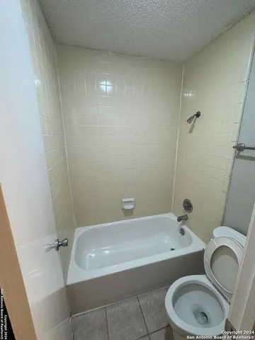 a bathroom with a sink a toilet and bathtub