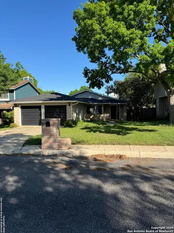 a front view of a house with a big yard