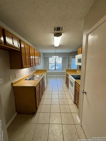 a kitchen with stainless steel appliances granite countertop a sink and cabinets