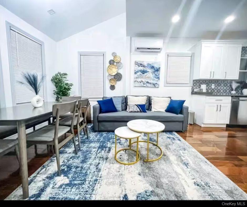 188-25 Keeseville Avenue, Unit 1 Queens, NY 11412 - Photo 2 of 8 a living room with furniture and a wooden floor