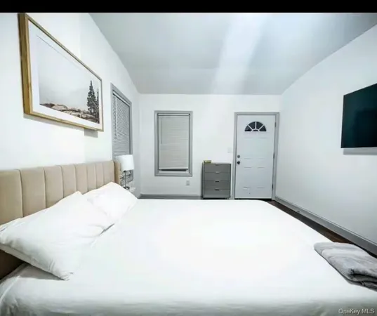 a large white bed in a white room