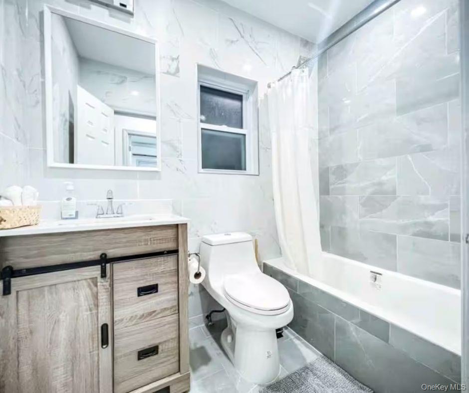 188-25 Keeseville Avenue, Unit 1 Queens, NY 11412 - Photo 8 of 8 a bathroom with a sink a toilet and shower