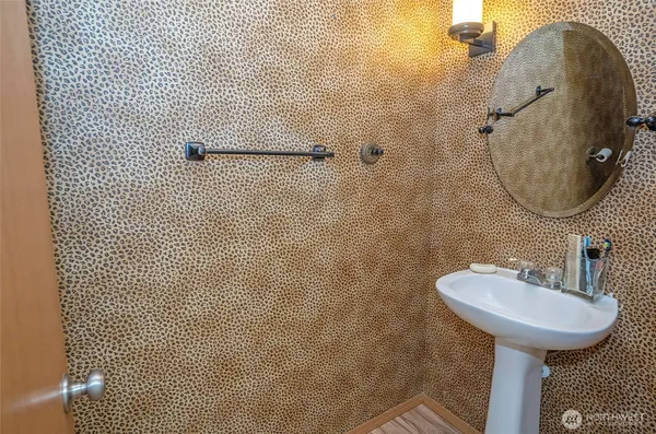 a bathroom with a sink toilet and mirror