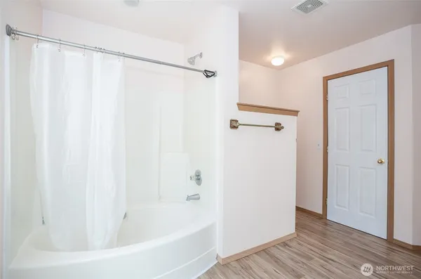 a bathroom with a bathtub and a shower