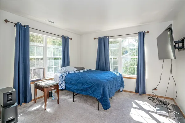 a bedroom with a bed and a window