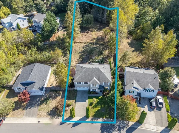 an aerial view of a house with a yard basket ball court and outdoor seating