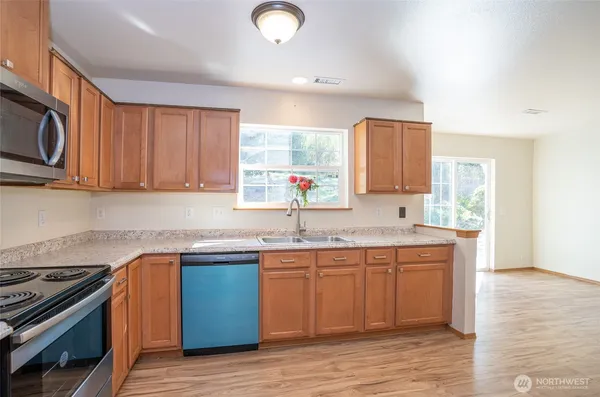 a kitchen with stainless steel appliances granite countertop a sink and stove top oven