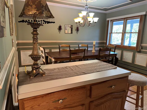 a view of a room with a chandelier furniture and windows