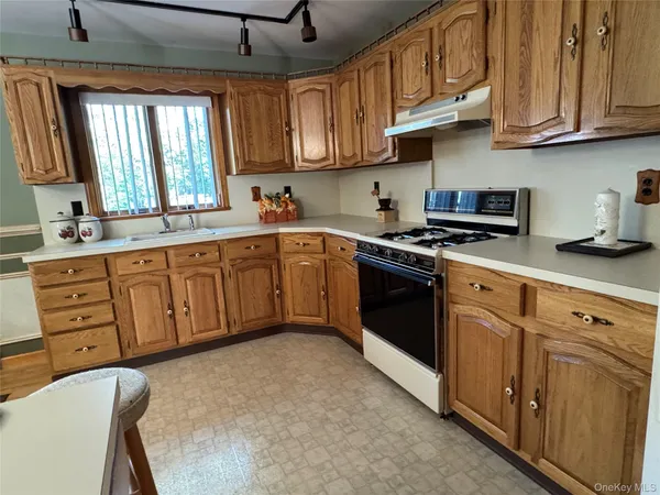 a kitchen with stainless steel appliances granite countertop a stove sink microwave and cabinets