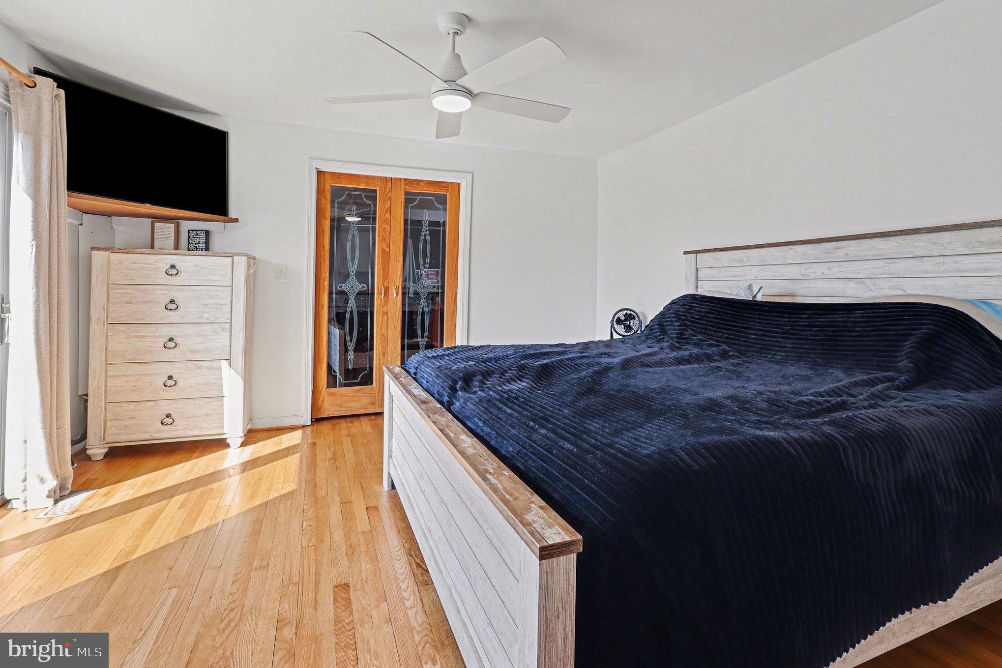 5408 Lewiston Road Spotsylvania, VA 22551 - Photo 13 of 32 a spacious bedroom with a bed and a flat screen tv
