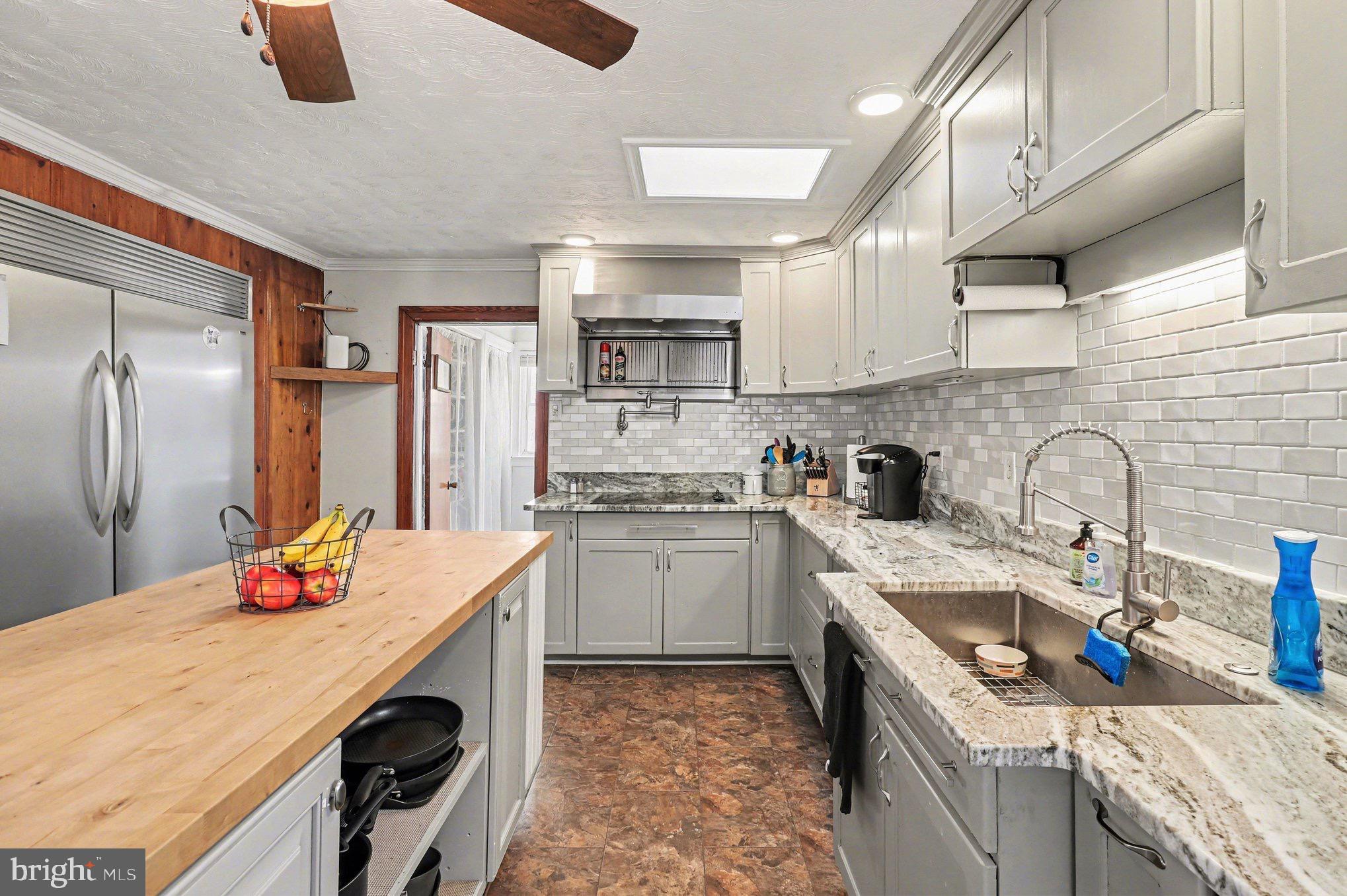 5408 Lewiston Road Spotsylvania, VA 22551 - Photo 5 of 32 a kitchen that has a sink and a stove in it