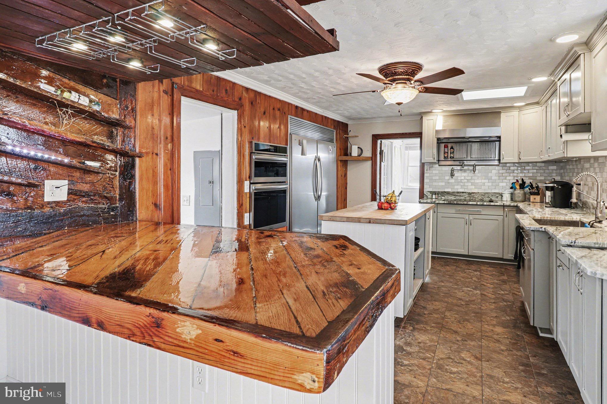 5408 Lewiston Road Spotsylvania, VA 22551 - Photo 6 of 32 a kitchen with stainless steel appliances granite countertop a sink stove and refrigerator