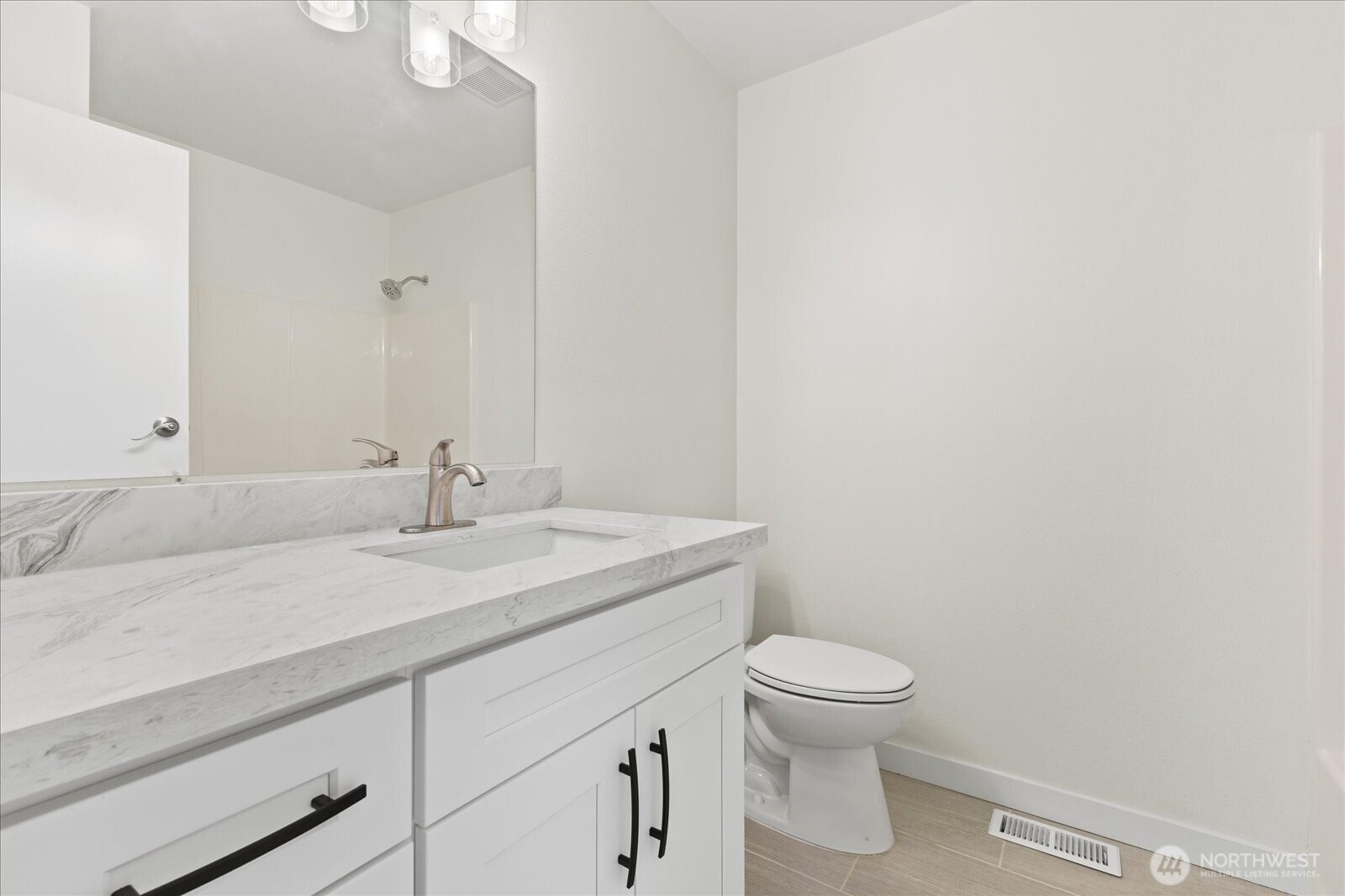 422 East Titus Street Kent, WA 98030 - Photo 20 of 28 a bathroom with a granite countertop sink a toilet and a mirror