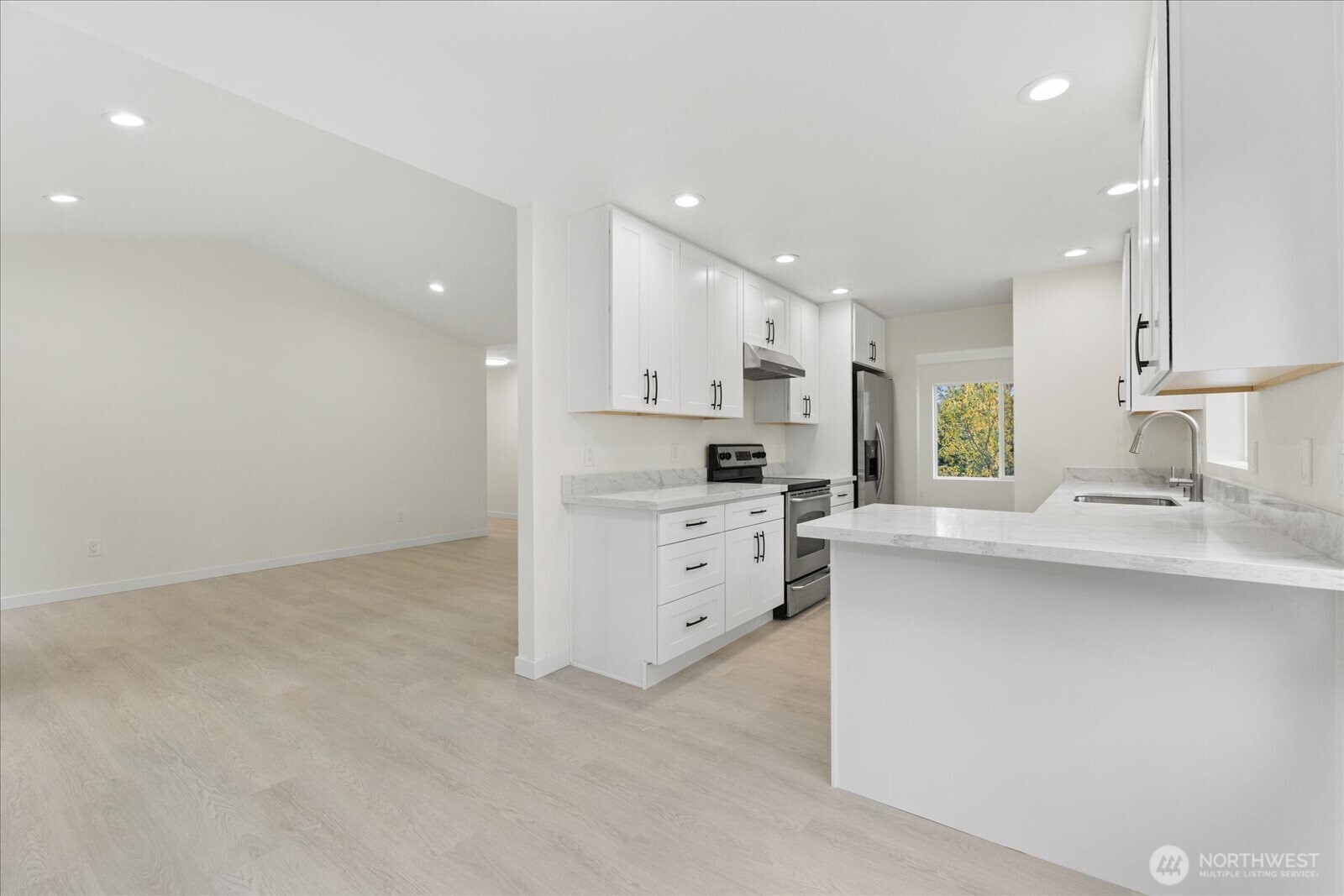 422 East Titus Street Kent, WA 98030 - Photo 8 of 28 a kitchen with white cabinets and stainless steel appliances