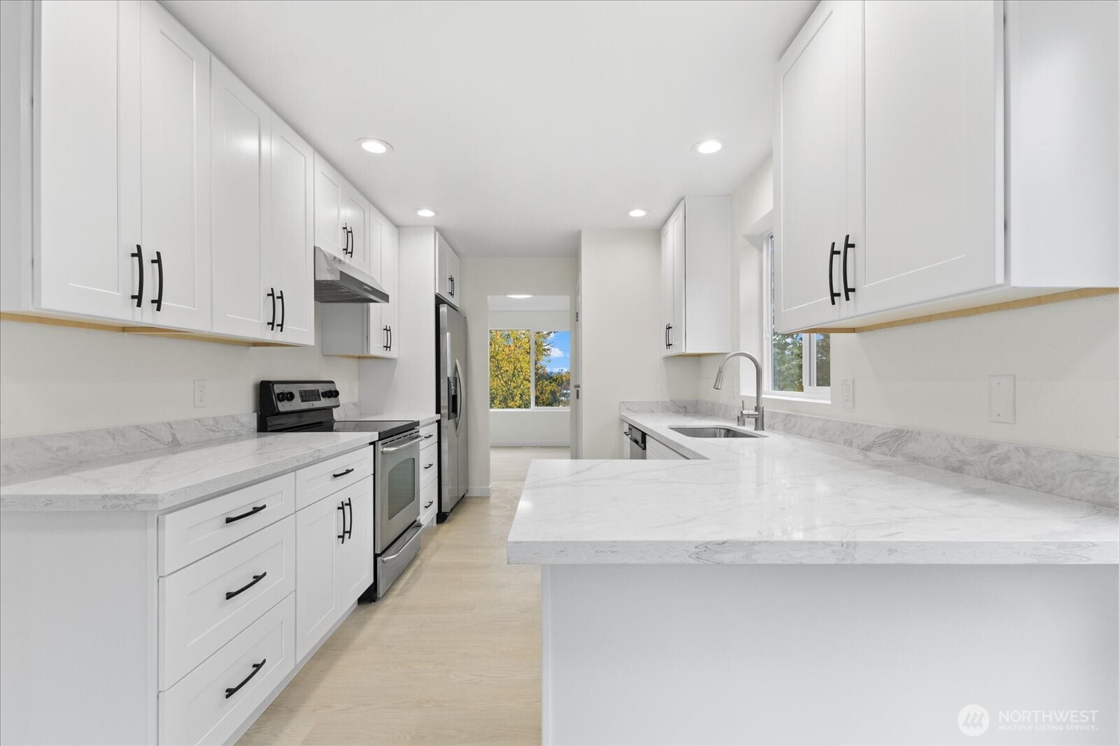 422 East Titus Street Kent, WA 98030 - Photo 9 of 28 a large white kitchen with cabinets