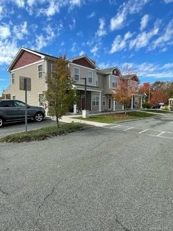 a view of a house with a yard and sitting area