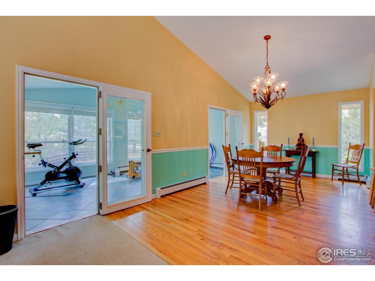 1908 Apple Valley Road Lyons, CO 80540 - Photo 13 of 40 a view of a dining room with furniture and wooden floor