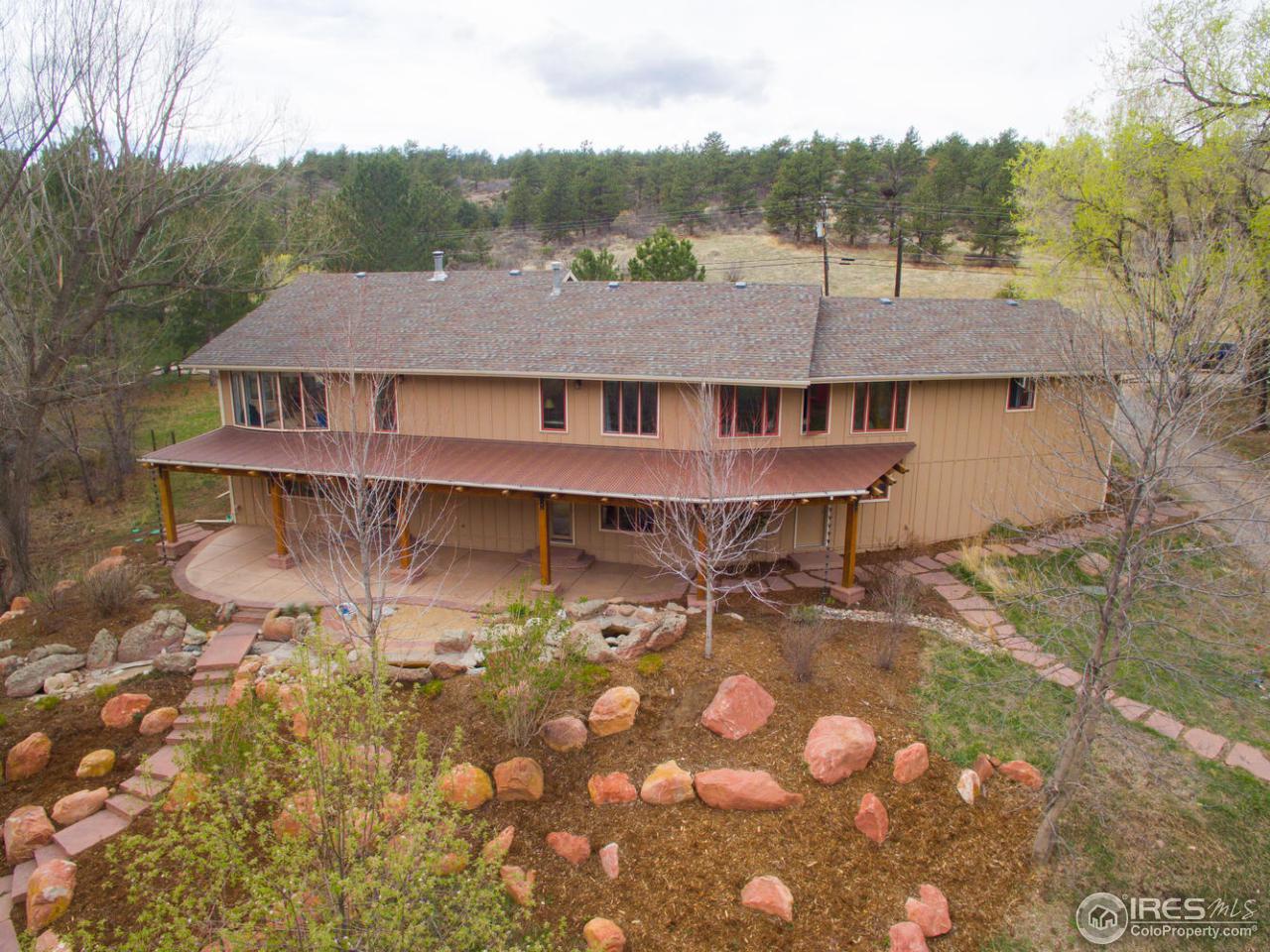 1908 Apple Valley Road Lyons, CO 80540 - Photo 2 of 40 a backyard of a house with table and chairs