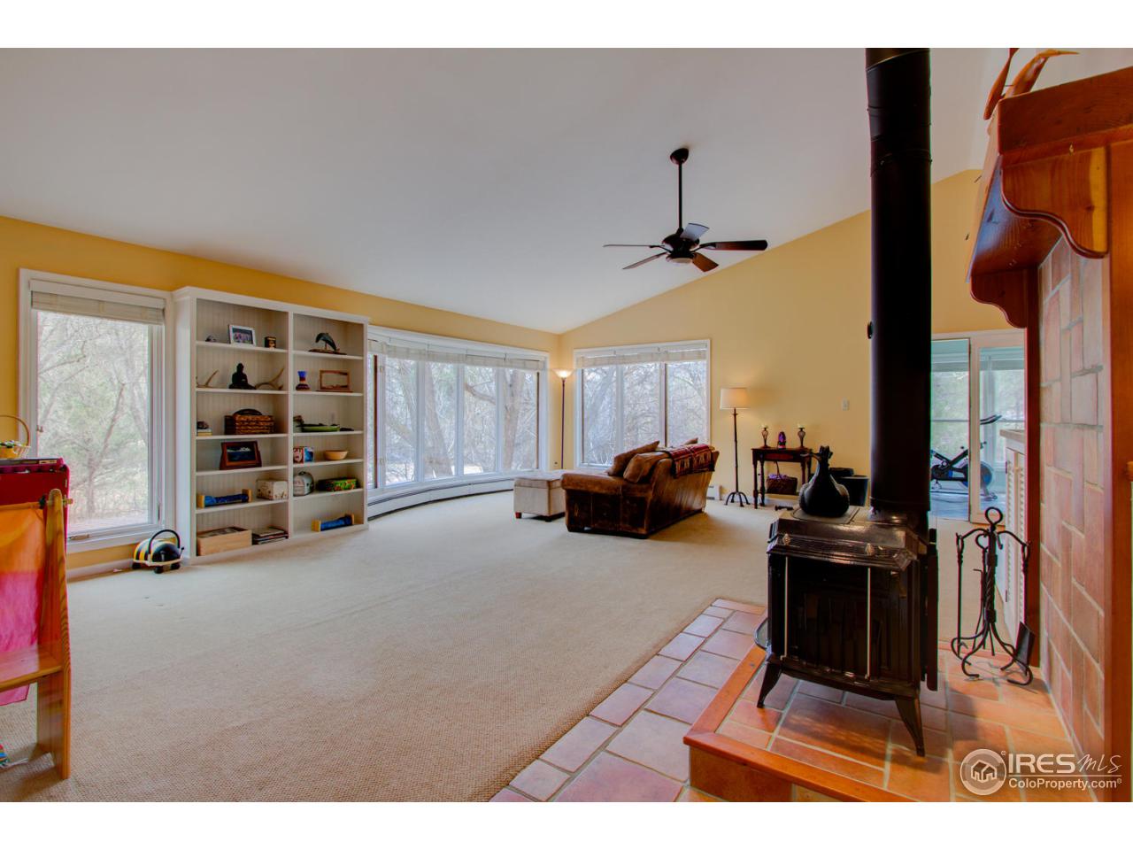 1908 Apple Valley Road Lyons, CO 80540 - Photo 8 of 40 a living room with furniture a air conditioner vent and a window
