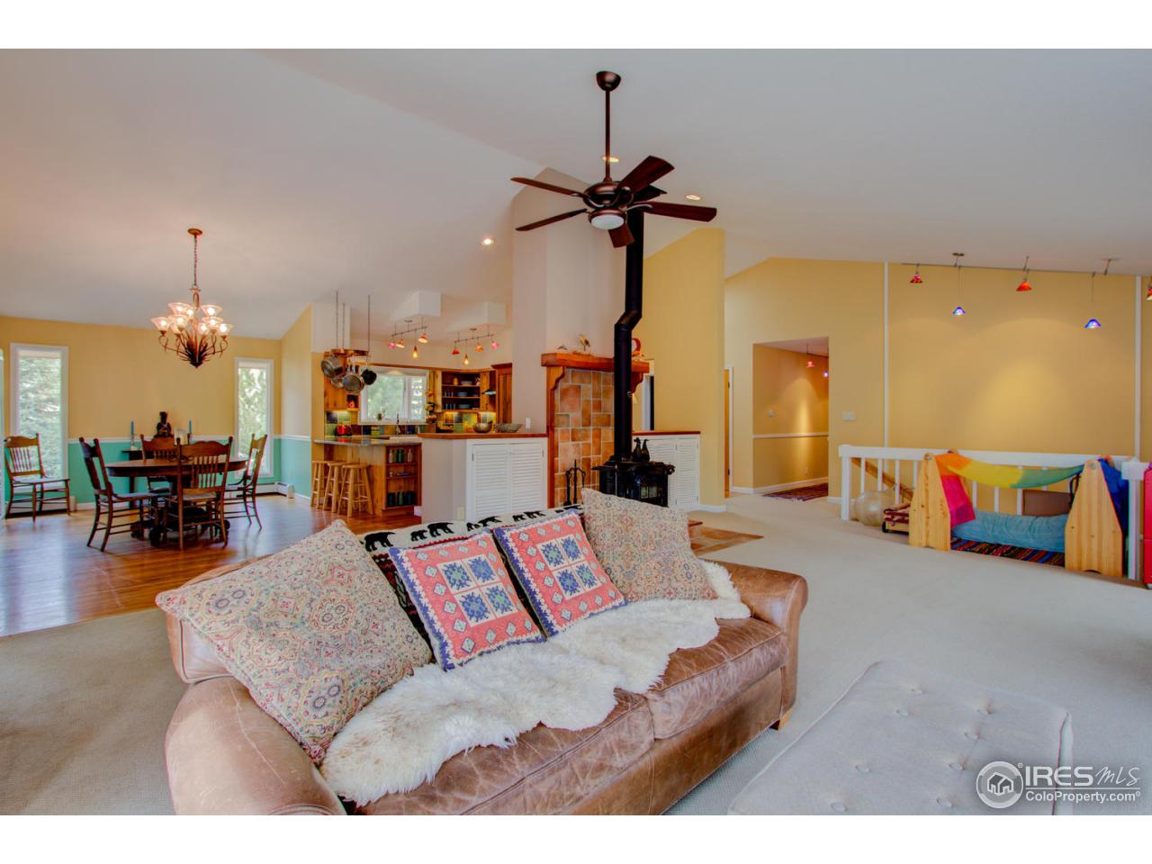1908 Apple Valley Road Lyons, CO 80540 - Photo 9 of 40 a living room with furniture and wooden floor