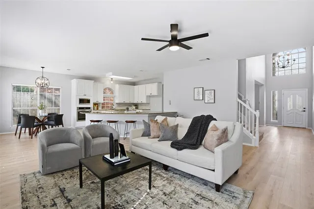 a living room with furniture and a view of kitchen