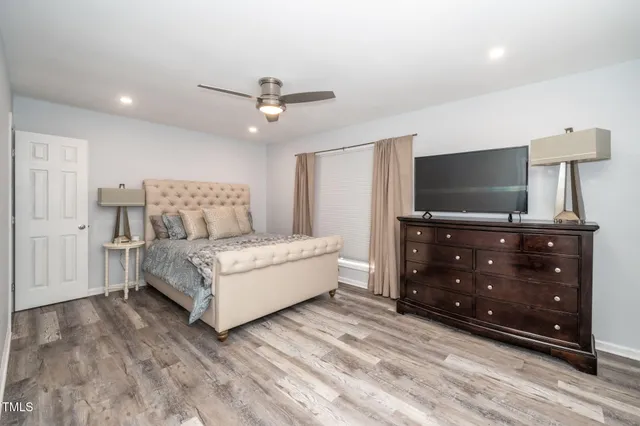 a bedroom with a bed and a flat screen tv