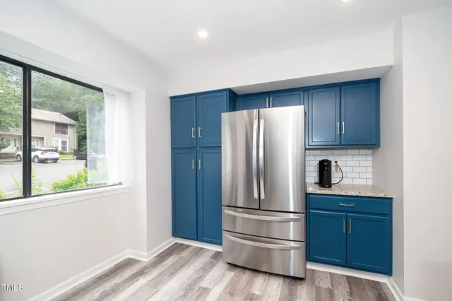 a kitchen with a refrigerator and window