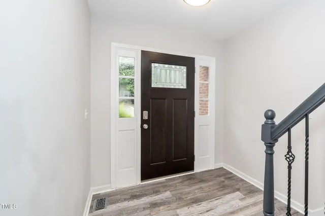 a view of an entryway with wooden floor