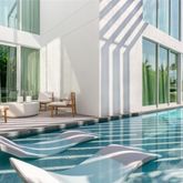 a view of a ocean with boats and trees in the background