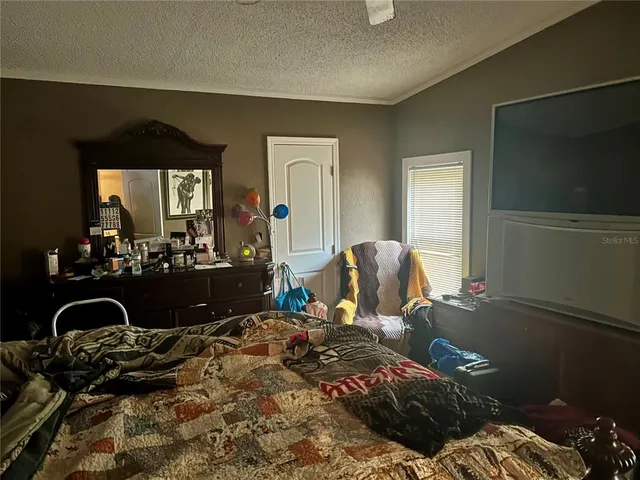 a bed sitting in a bedroom next to a small yard