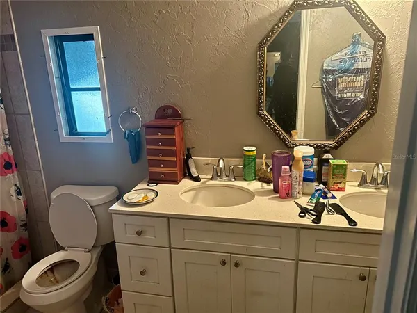 a bed room with a bed and mirror