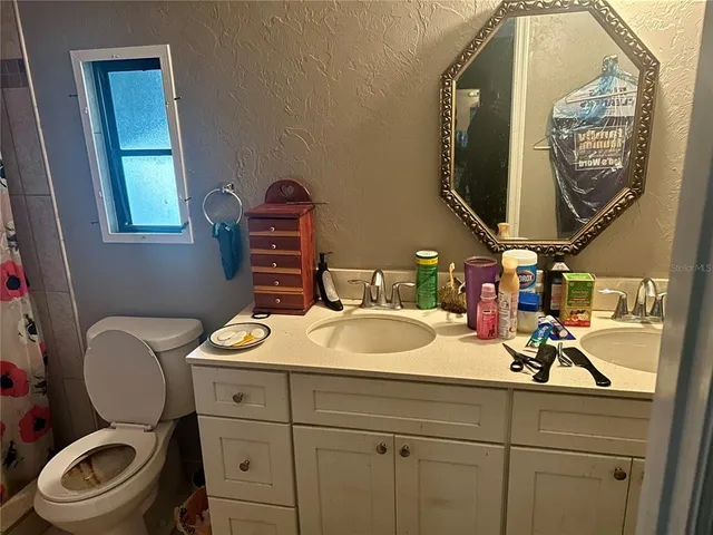 a bed room with a bed and mirror