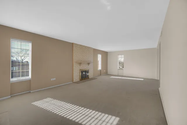a view of a livingroom with wooden floor and bathroom
