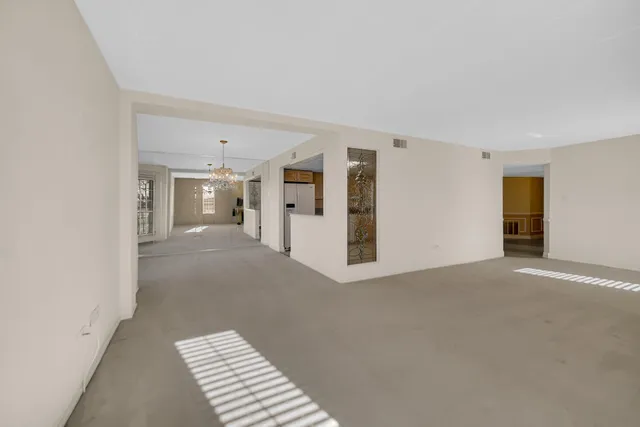 a view of a kitchen with a sink and refrigerator