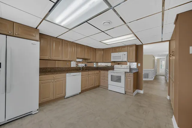 a view of an empty room with a fireplace and a window