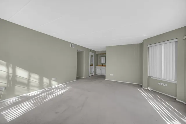 a spacious bathroom with a double vanity sink a mirror and a toilet