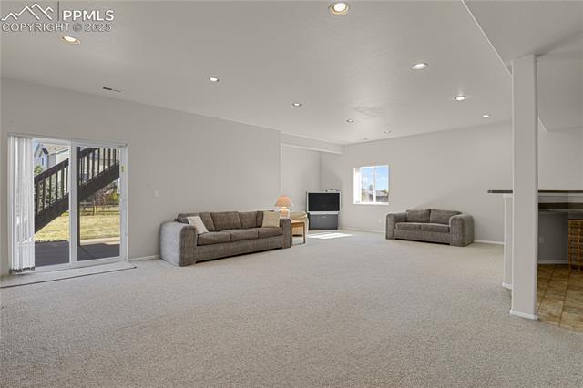12237 Rio Secco Road Peyton, CO 80831 - Photo 28 of 45 Walkout basement family room featuring a healthy amount of sunlight