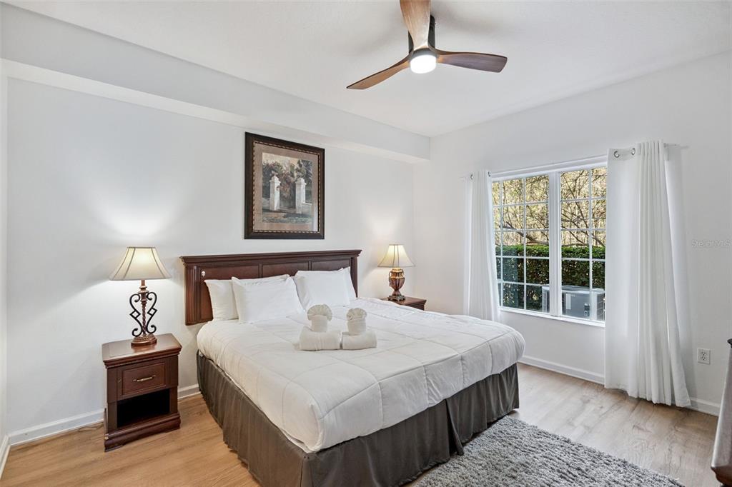 8762 Worldquest Boulevard, Unit 5103 Orlando, FL 32821 - Photo 11 of 30 a bedroom with bed and window