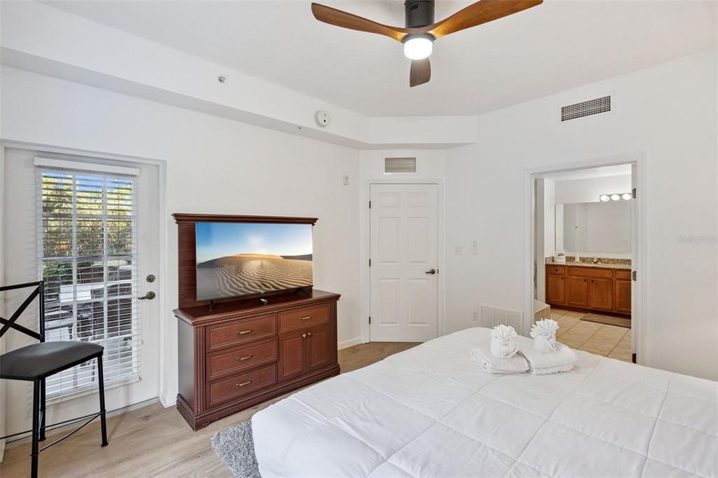 8762 Worldquest Boulevard, Unit 5103 Orlando, FL 32821 - Photo 12 of 30 a bedroom with a bed and a television