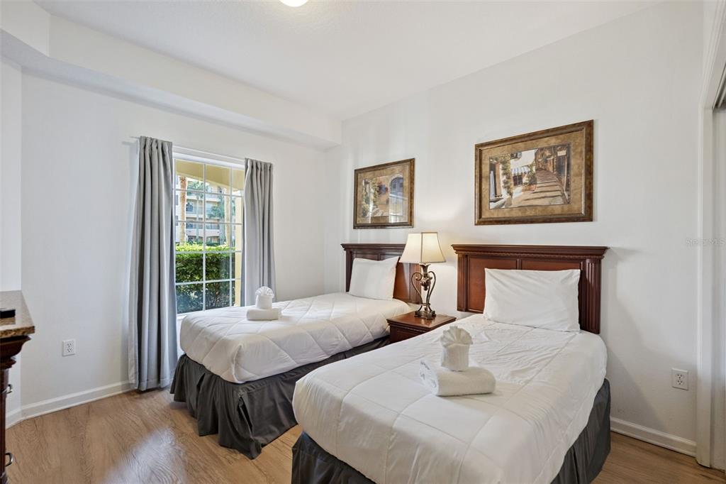 8762 Worldquest Boulevard, Unit 5103 Orlando, FL 32821 - Photo 13 of 30 a bedroom with two beds and a window