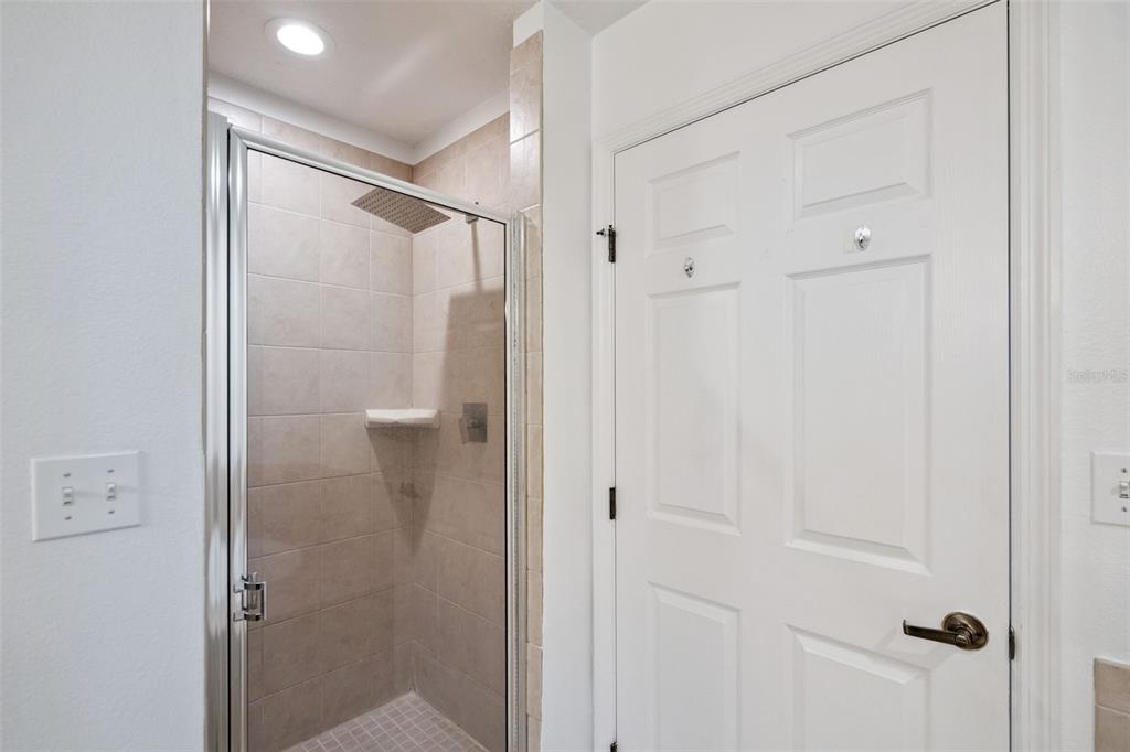 8762 Worldquest Boulevard, Unit 5103 Orlando, FL 32821 - Photo 18 of 30 a bathroom with a glass shower door